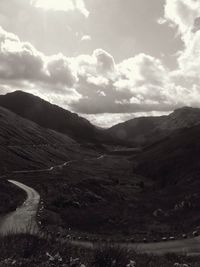 Scenic view of mountains against cloudy sky