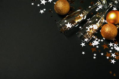 High angle view of christmas decorations on table against black background