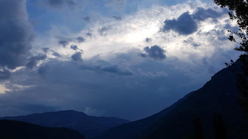 Low angle view of silhouette mountains against sky