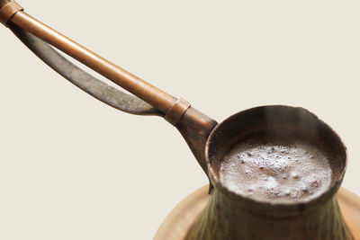 Close-up of coffee cup against white background