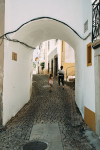 Rear view of woman walking in abandoned building