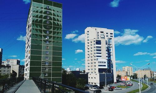 View of city street against blue sky