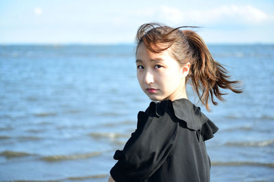 Portrait of boy standing on beach