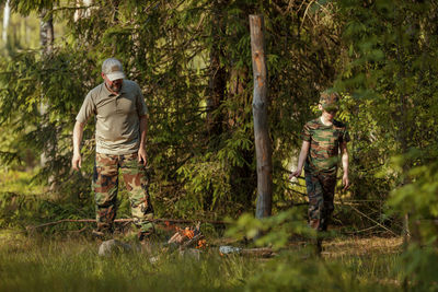 Rear view of soldiers standing in forest