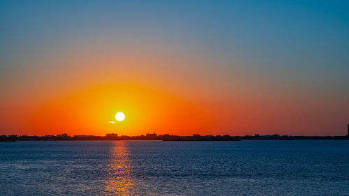 Scenic view of sea against romantic sky at sunset
