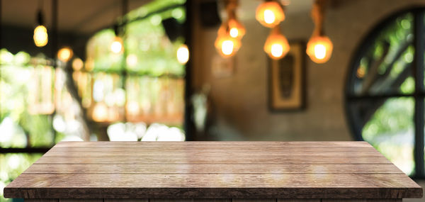 Close-up of empty bench on table in restaurant