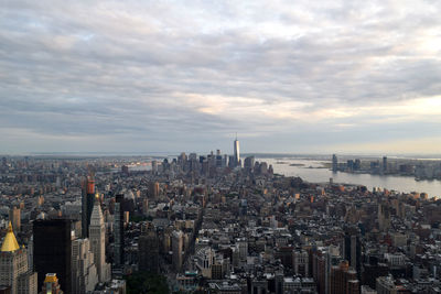 River by manhattan against cloudy sky