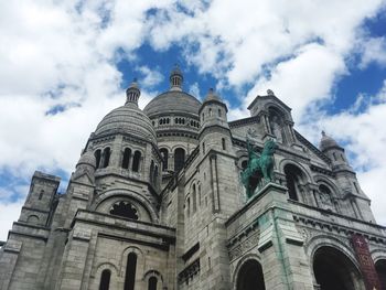 Low angle view of cathedral against cloudy sky