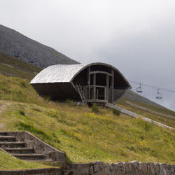 Built structure on mountain against sky