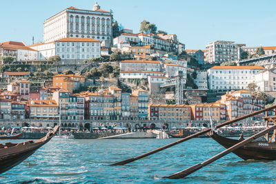 Boats in river in city