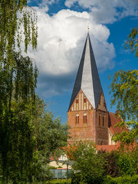 View of temple against building and sky