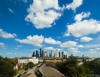 View of cityscape against cloudy sky