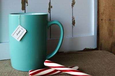 Close-up of drink with candy canes on table