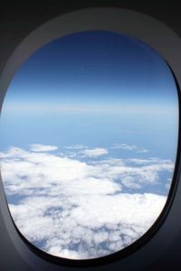 Cropped image of airplane wing over landscape