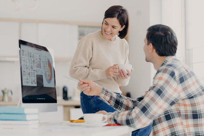 Couple working on desktop pc at home