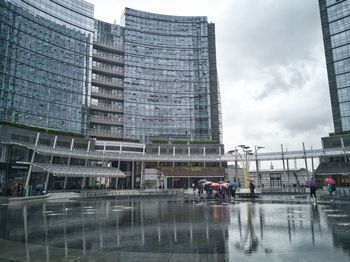 Reflection of buildings on wet glass in city