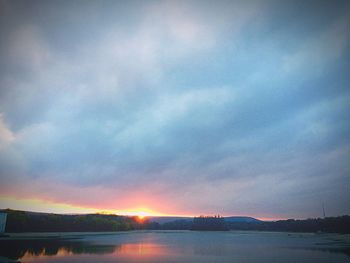 Scenic view of lake against sky at sunset