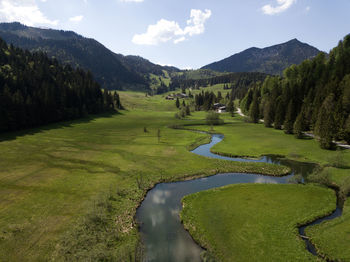 River flowing through green grass in the bavarian alps