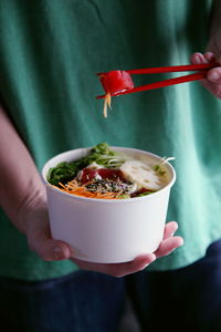 Close-up of hand holding food bowl