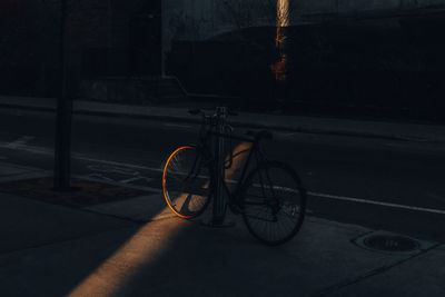 Bicycle parked on street at night