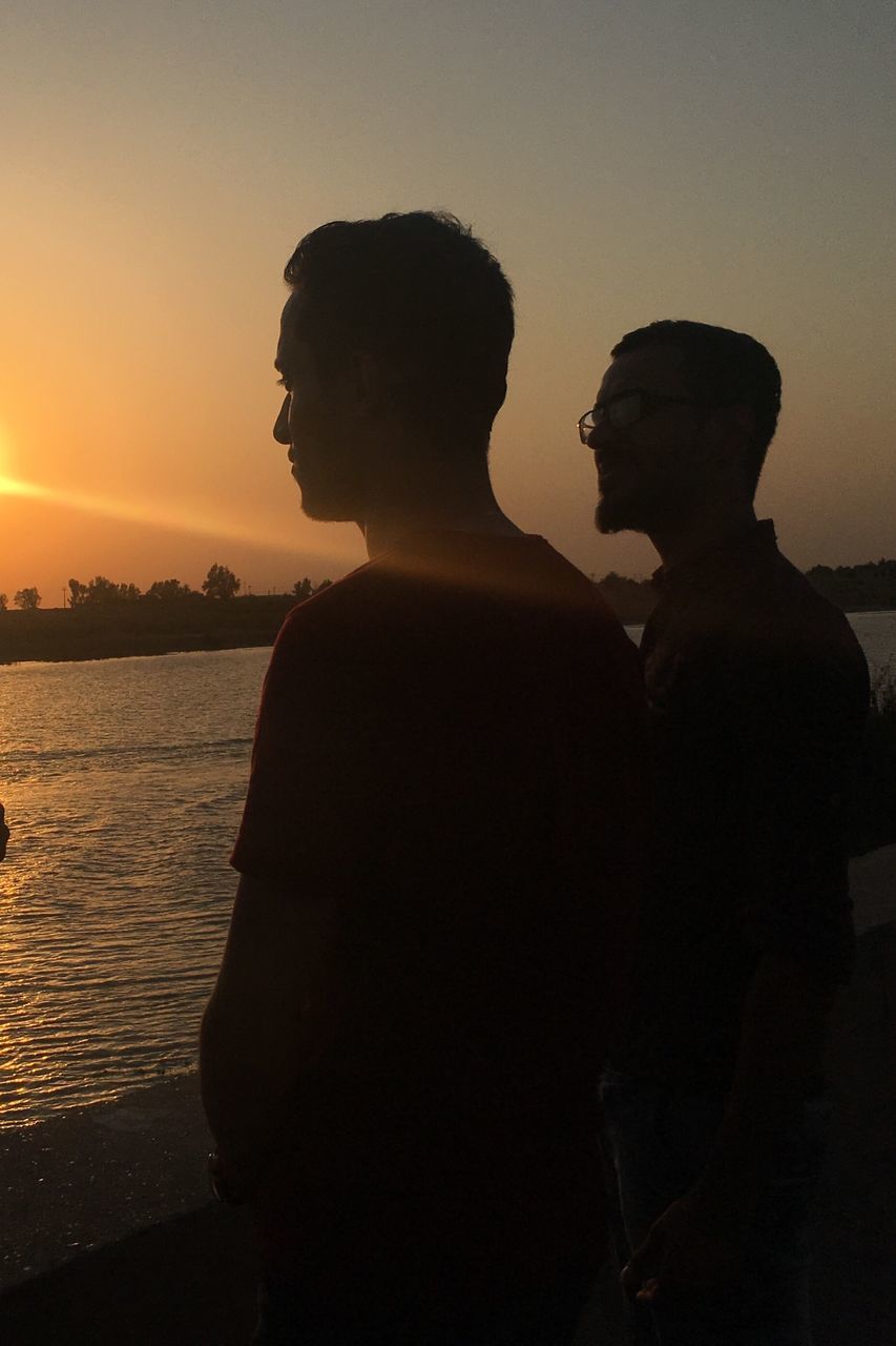 SILHOUETTE MEN STANDING AGAINST SKY DURING SUNSET