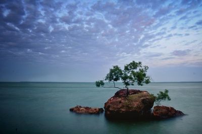 Scenic view of sea against cloudy sky