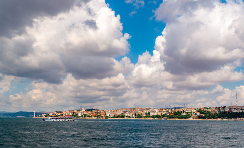 Scenic view of sea by buildings against sky