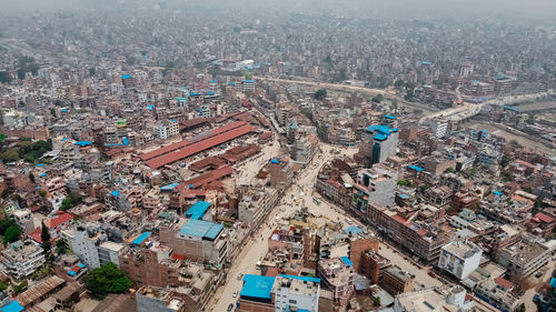 High angle view of crowd and buildings in city