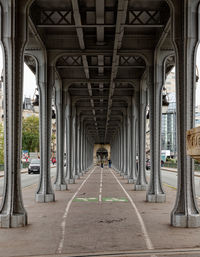 Rear view of man walking in tunnel