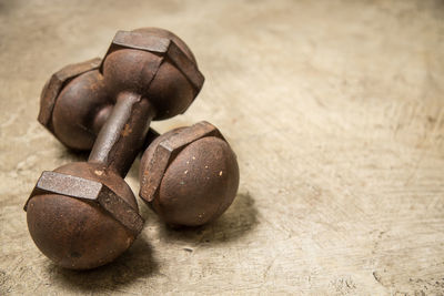 Close-up of rusty dumbbells on table