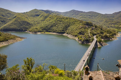 High angle view of river amidst mountains against sky