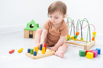 Boy playing with toy blocks on table