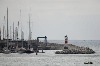 Sailboats on sea against sky