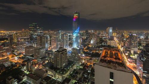 Aerial view of illuminated buildings in city at night