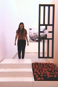 Portrait of woman standing against wall at home