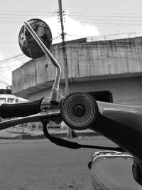 Close-up of motorcycle against sky