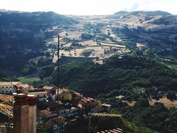 High angle view of houses and trees against sky