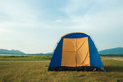 Tent on field against sky