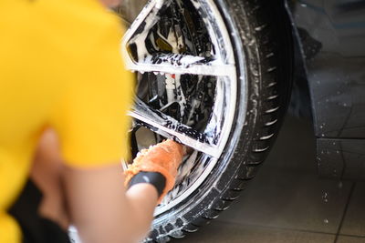 Midsection of woman cleaning car