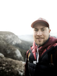 Portrait of young man against mountains