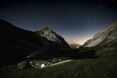 Scenic view of mountains against sky at night