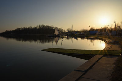 Sailboats in lake at sunset