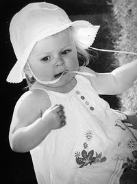 Cute baby girl looking down outdoors