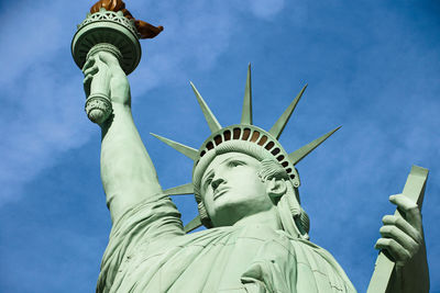 Low angle view of statue against blue sky