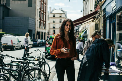 Woman standing on street in city