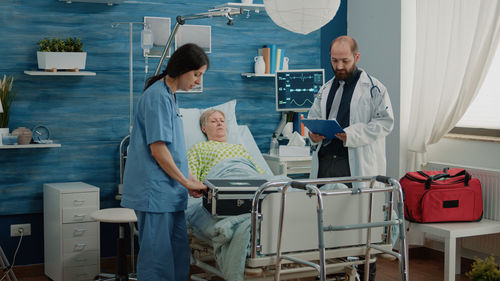 Doctor and nurse examining patient at hospital