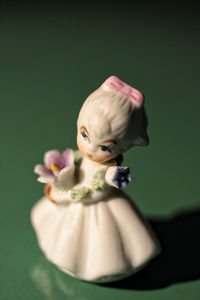 Close-up of figurine over white background