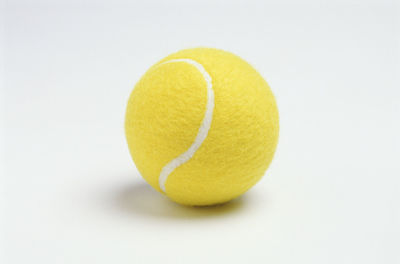 Close-up of yellow ball on white background