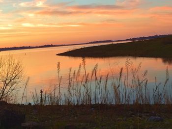 Scenic view of lake at sunset