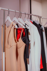 Designer fashion outfits hanging in a row at the backstage. spring summer fashion collection